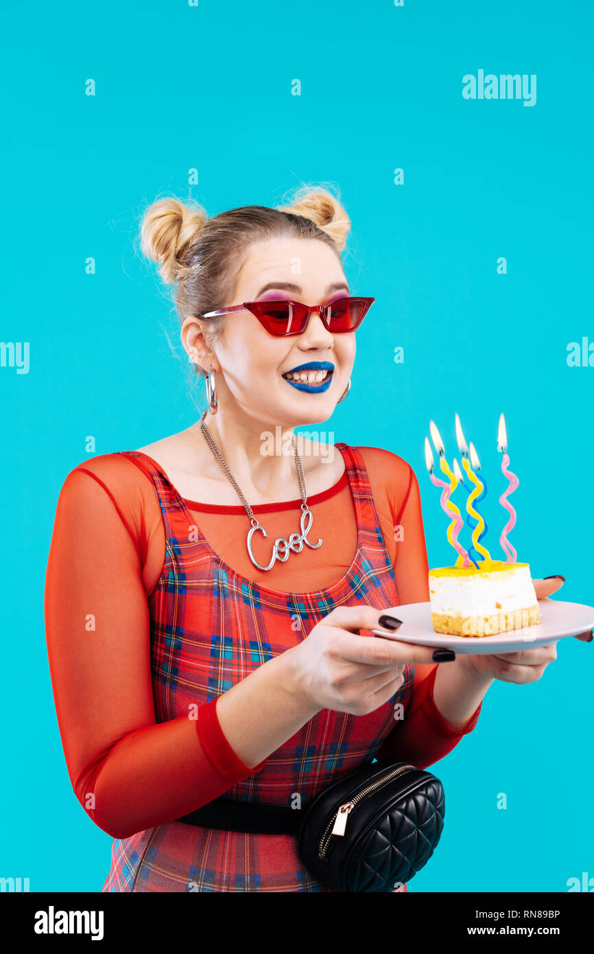 Woman wearing red shirt and glasses celebrating birthday Stock Photo