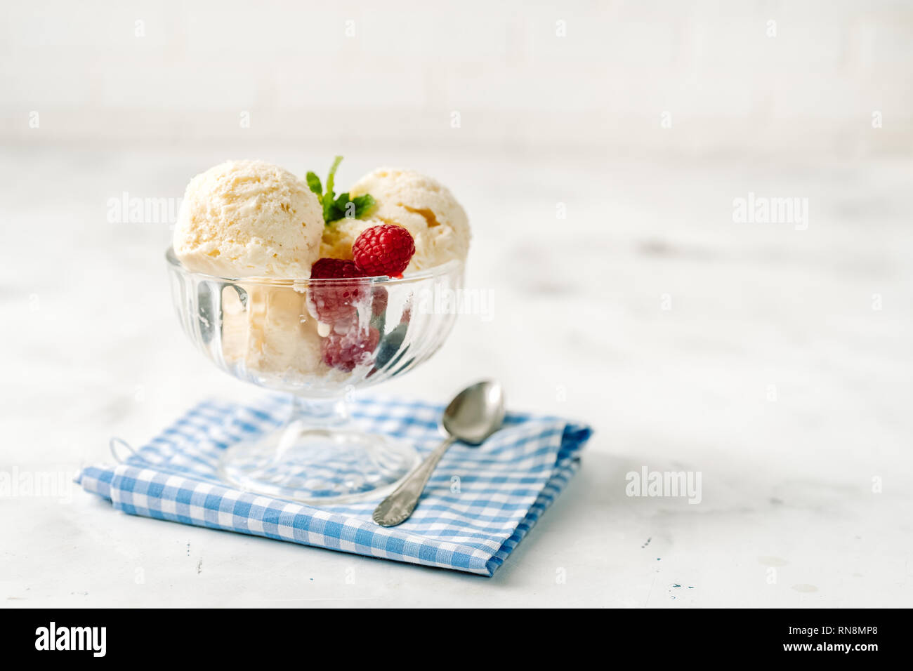 Vanilla ice cream with berries on white background Stock Photo