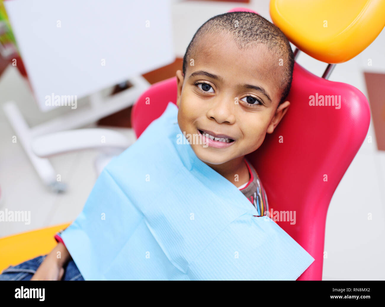 cute black baby boy African American smiling sitting in the dental chair  Stock Photo