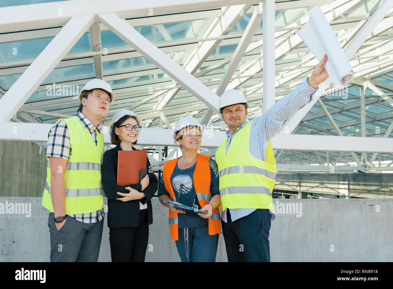 Team of builders engineer architect on the roof of construction site ...