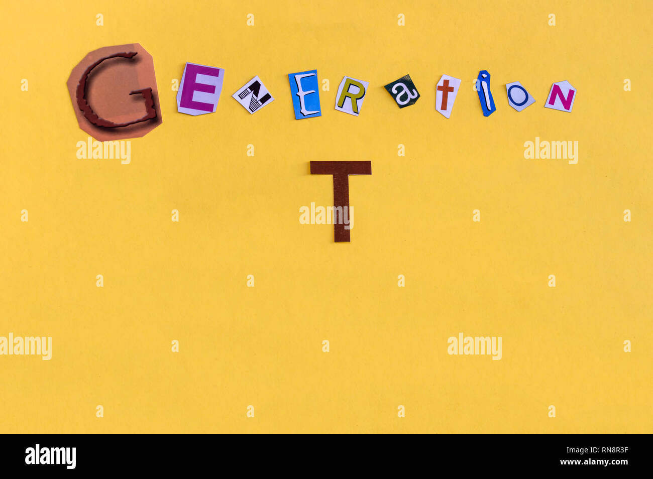 Word 'Generation T' formed with cut letters. The new generation of technology after Millennial also called Alpha Generation or Children of Millennials Stock Photo