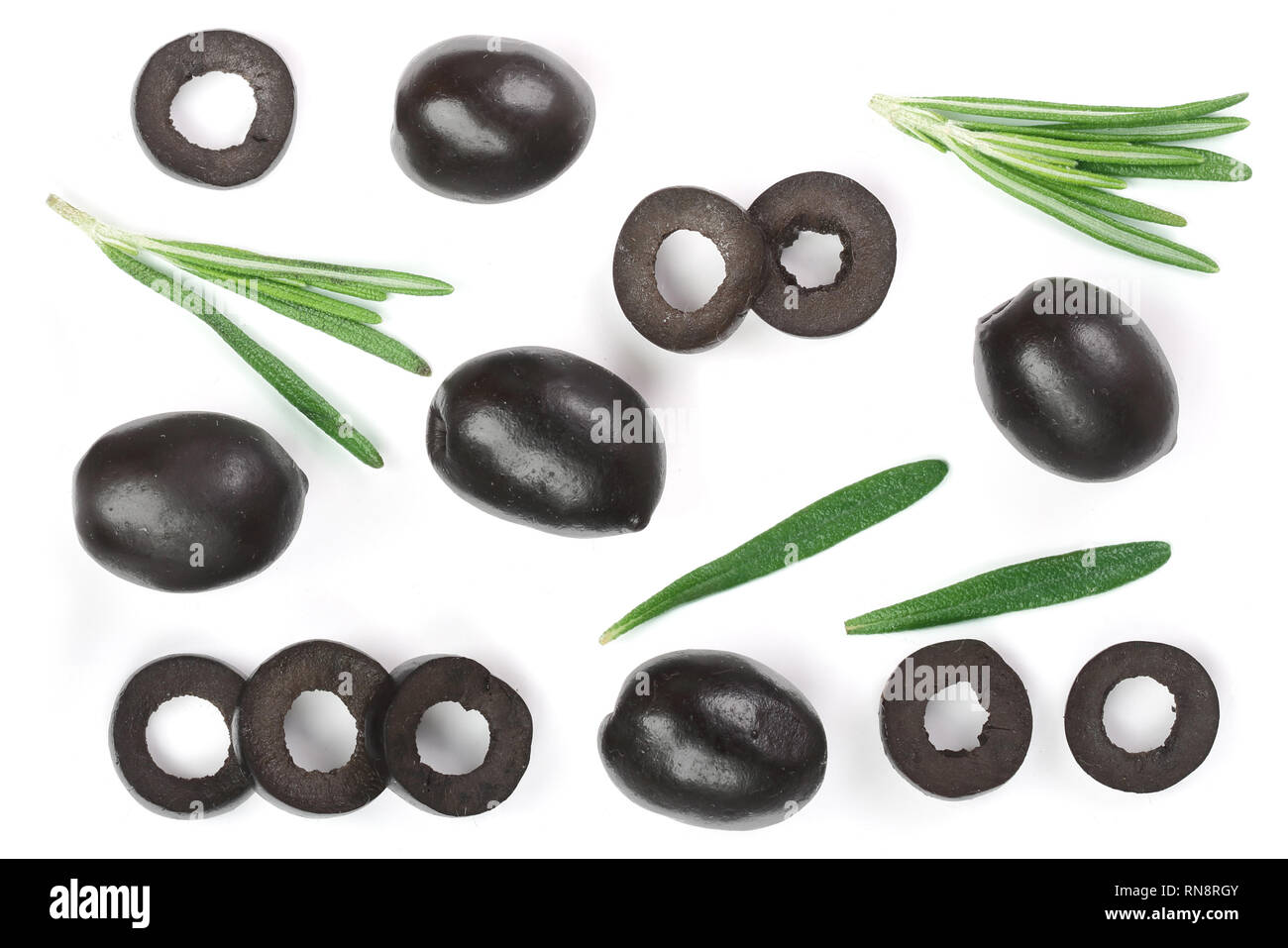 whole and sliced black olives with rosemary leaves isolated on white background. Top view. Flat lay pattern Stock Photo