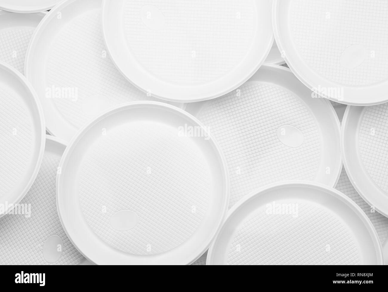 White plastic plates closeup Environmental problem concept Stock