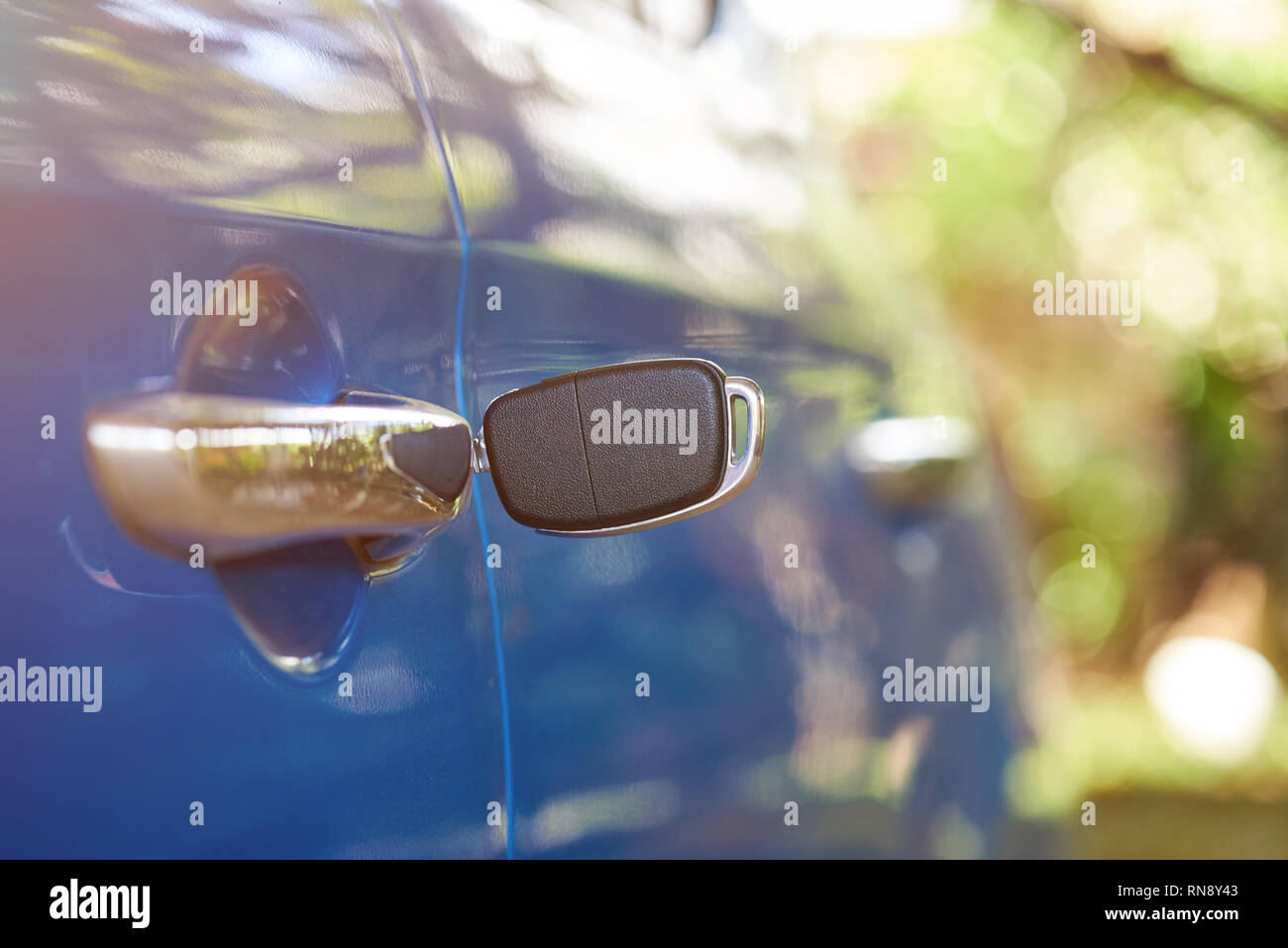 Car key in door lock on sunny blurred background Stock Photo - Alamy