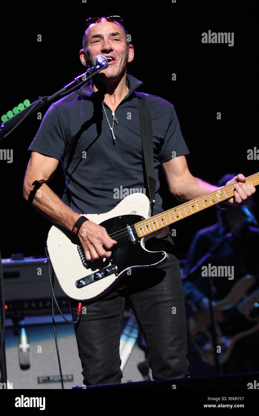 Guitarist and singer Simon Townshend is shown performing on stage with ...