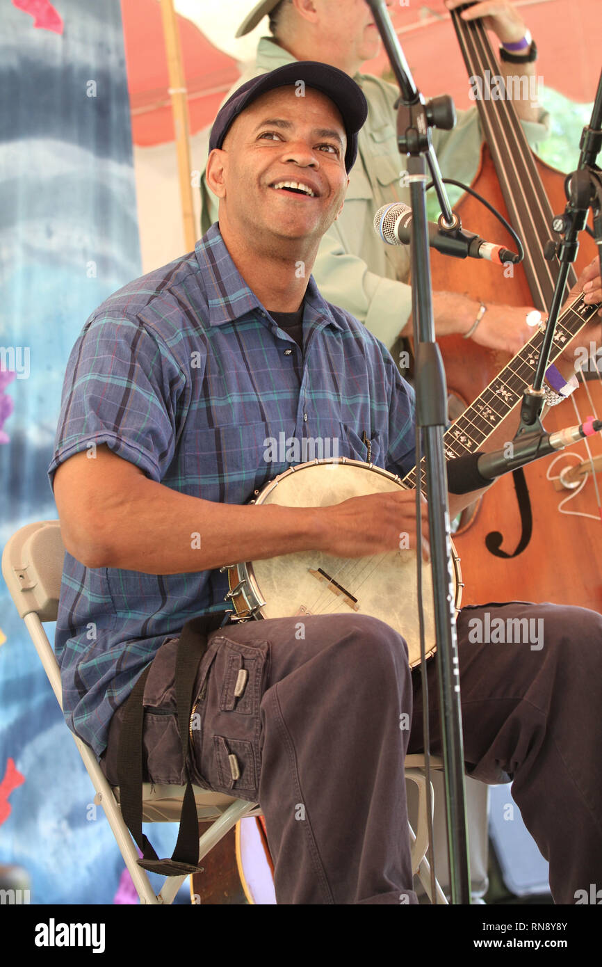 Musician Guy Davis is shown performing on stage during a "live" concert