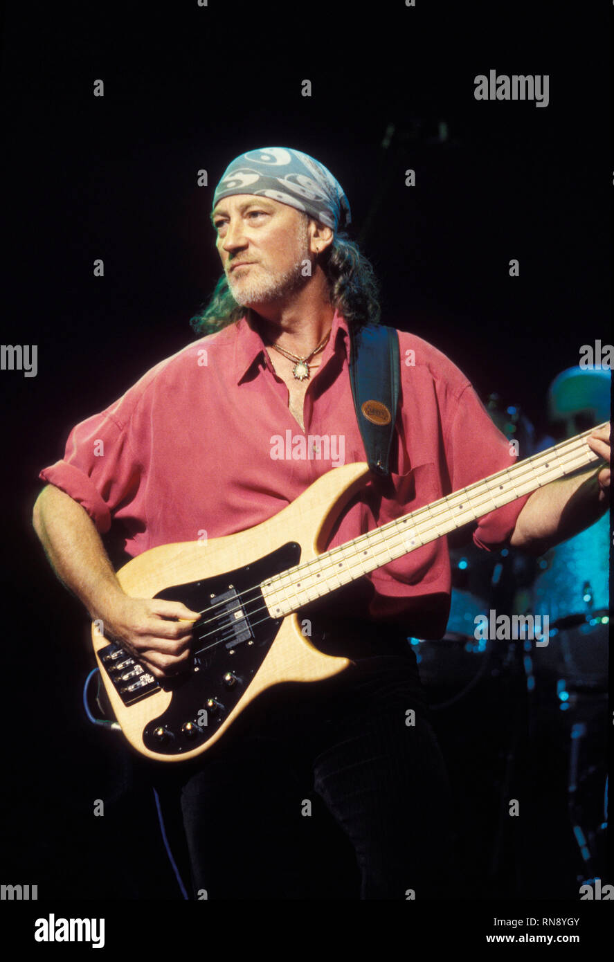 Deep Purple bassist Roger Glover is shown performing on stage during a 'live' concert appearance. Stock Photo