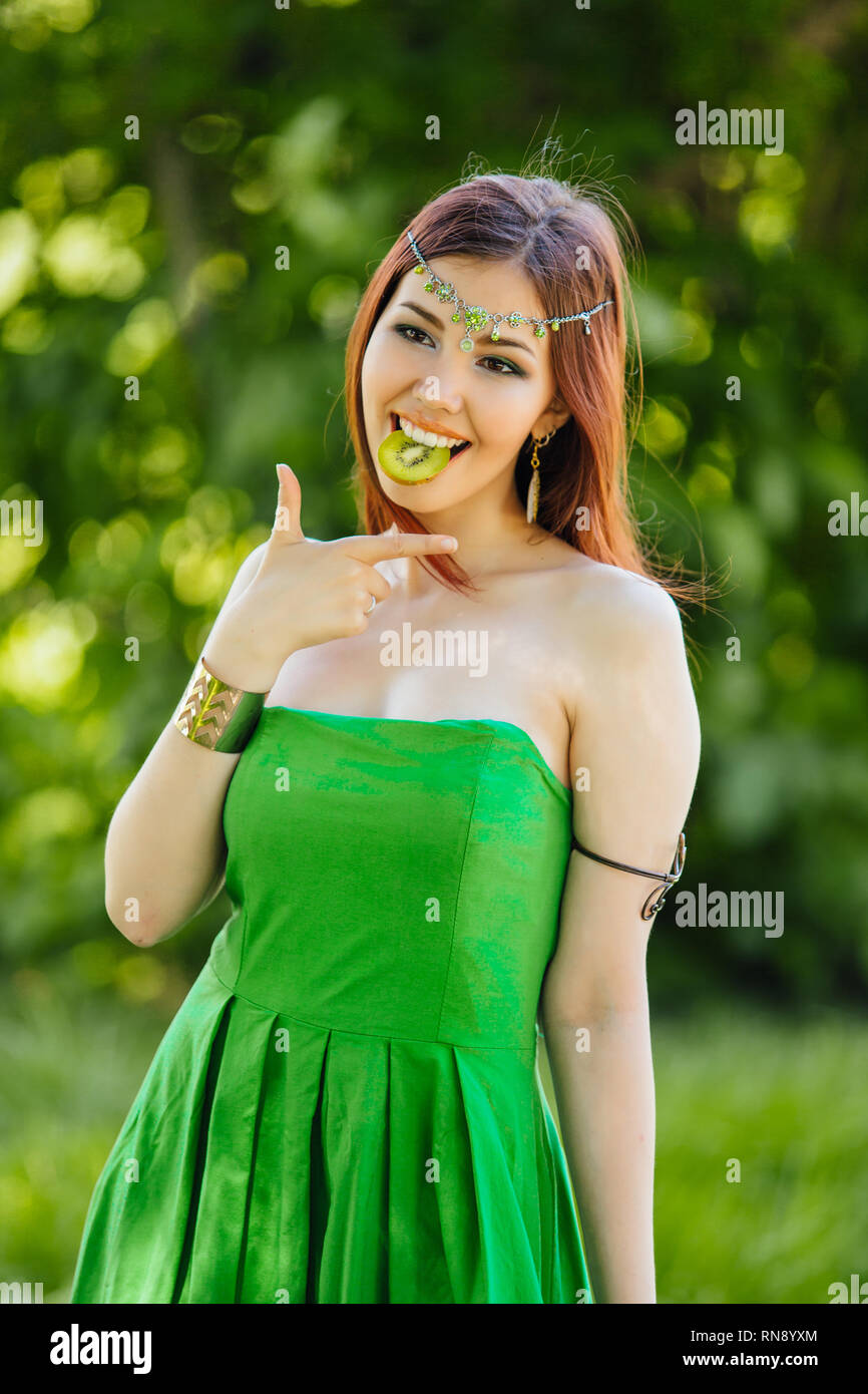 Portrait of a beautiful young asian woman in green dress and diadema on ...