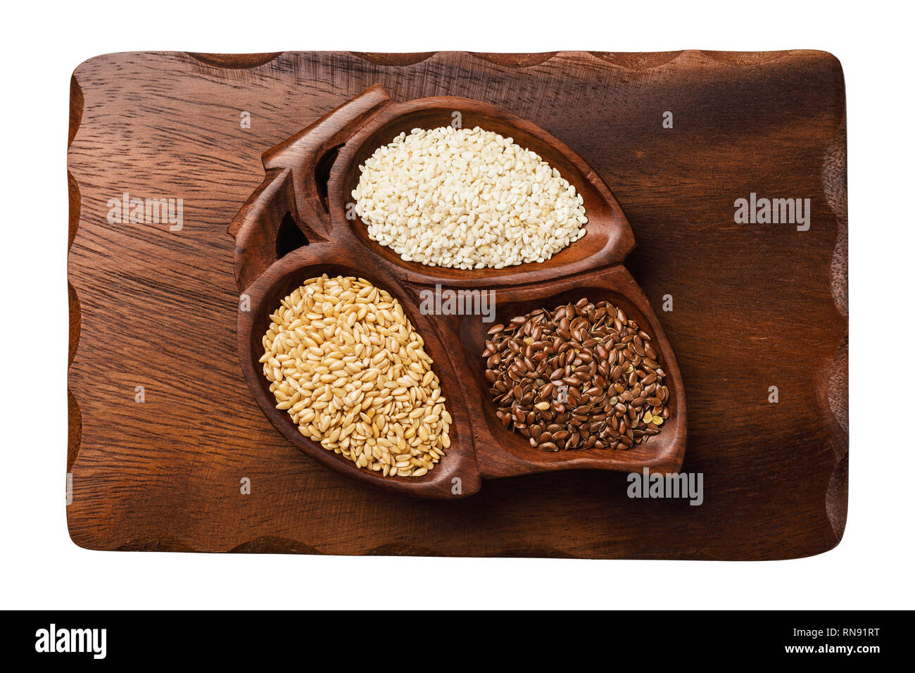 Flax and sesame seeds in a cup on a wooden stand isolated on white background Stock Photo