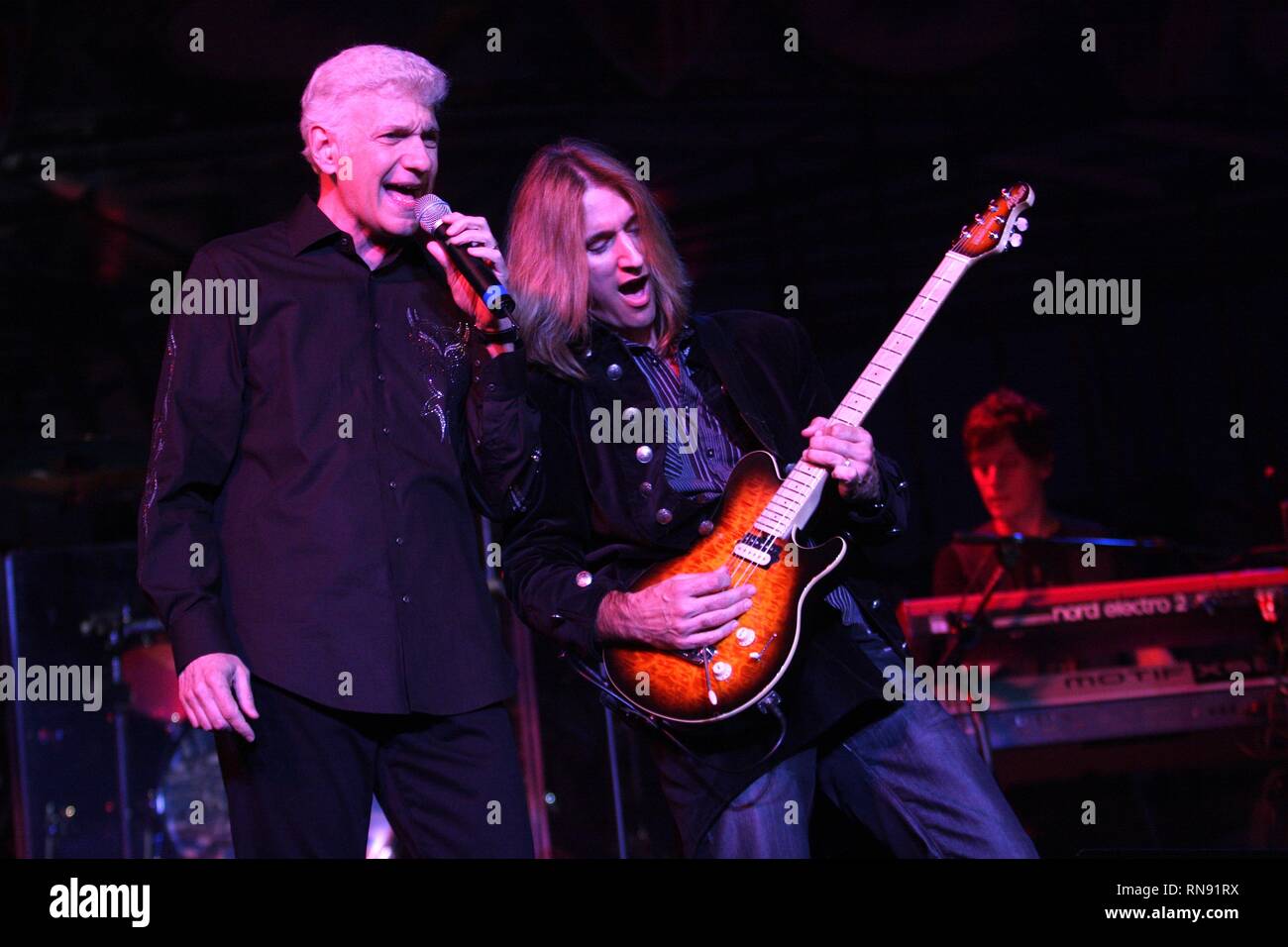 Former vocalist and keyboardist of Styx, Dennis DeYoung is shown performing on stage with his solo band during a 'live' concert appearance. Stock Photo