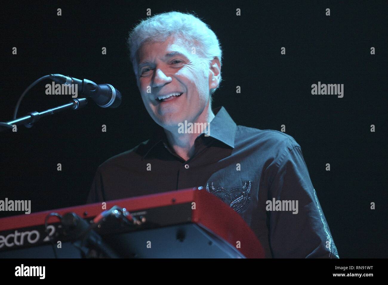 Former vocalist and keyboardist of Styx, Dennis DeYoung is shown performing on stage with his solo band during a 'live' concert appearance. Stock Photo