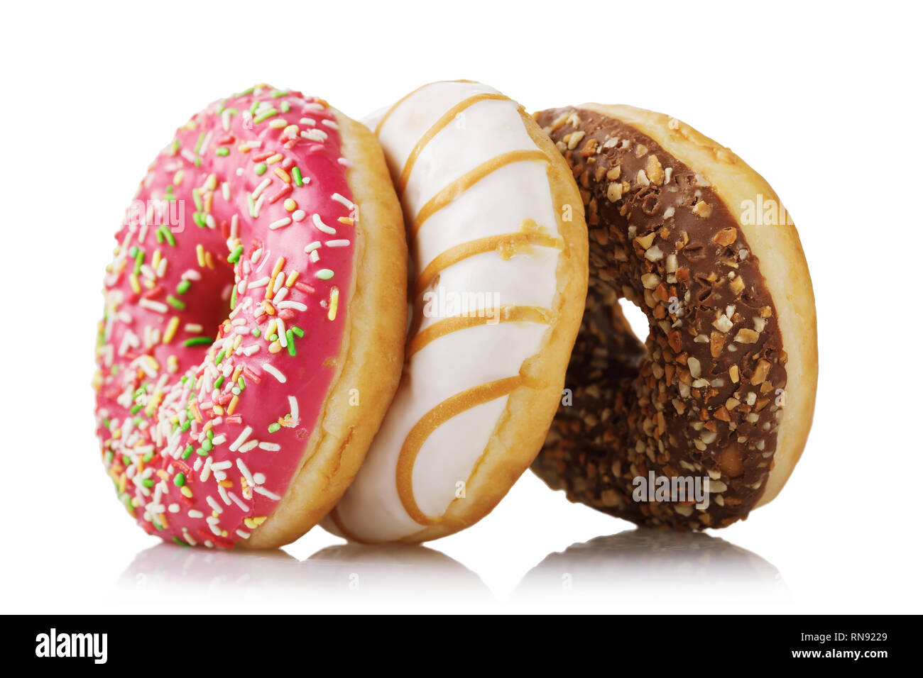 Three fresh donuts with various fillings isolated on white background Stock Photo