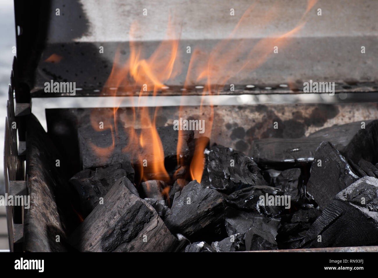 bright burning black coals in iron barbecue grill Stock Photo Alamy