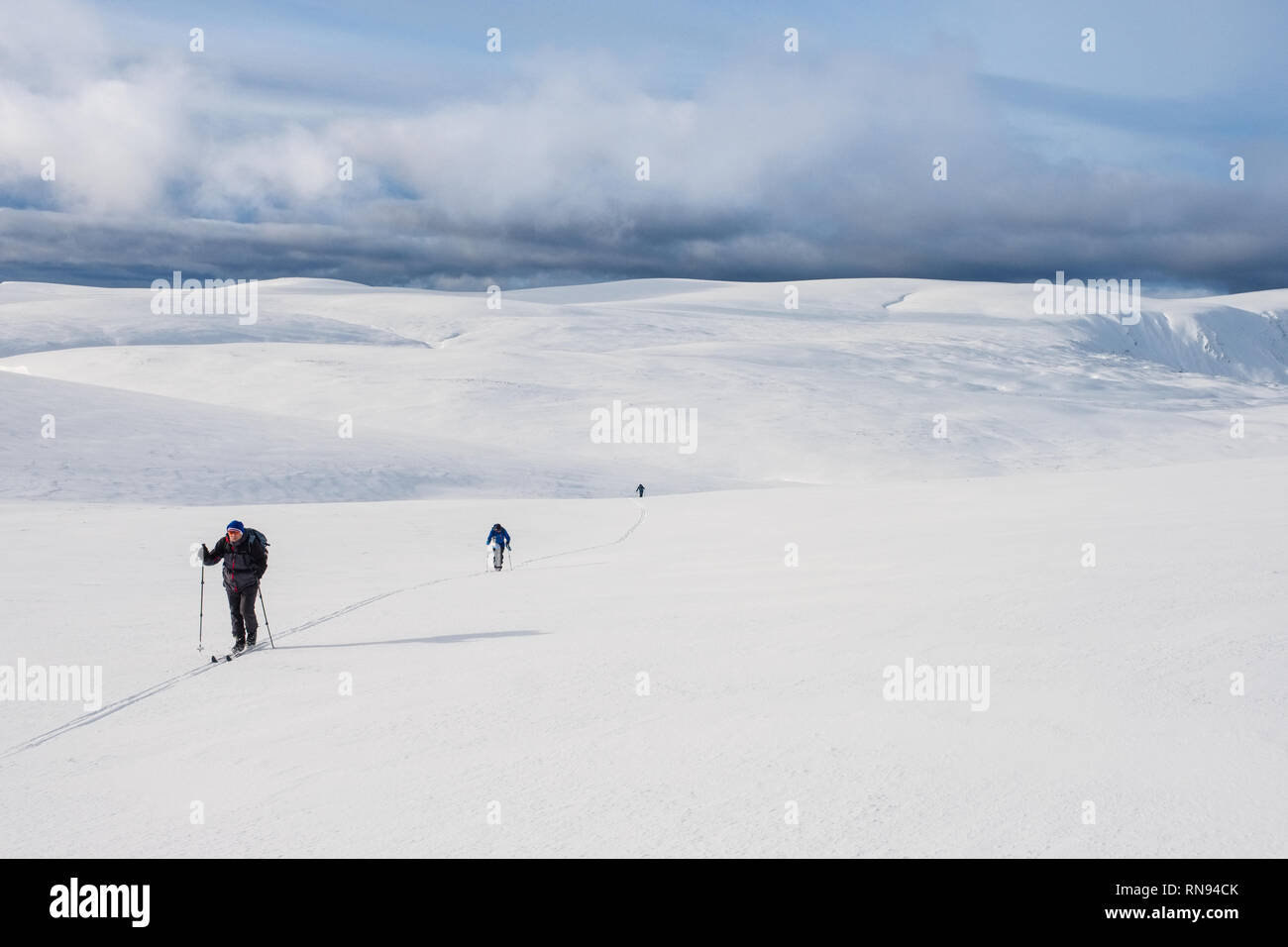 Group of ski-mountaineers ski touring on the Feshie plateau in the Cairngorm mountains, Scotland,UK Stock Photo