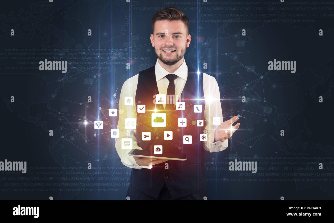 Handsome businessman in suit with tablet on his hand and application ...