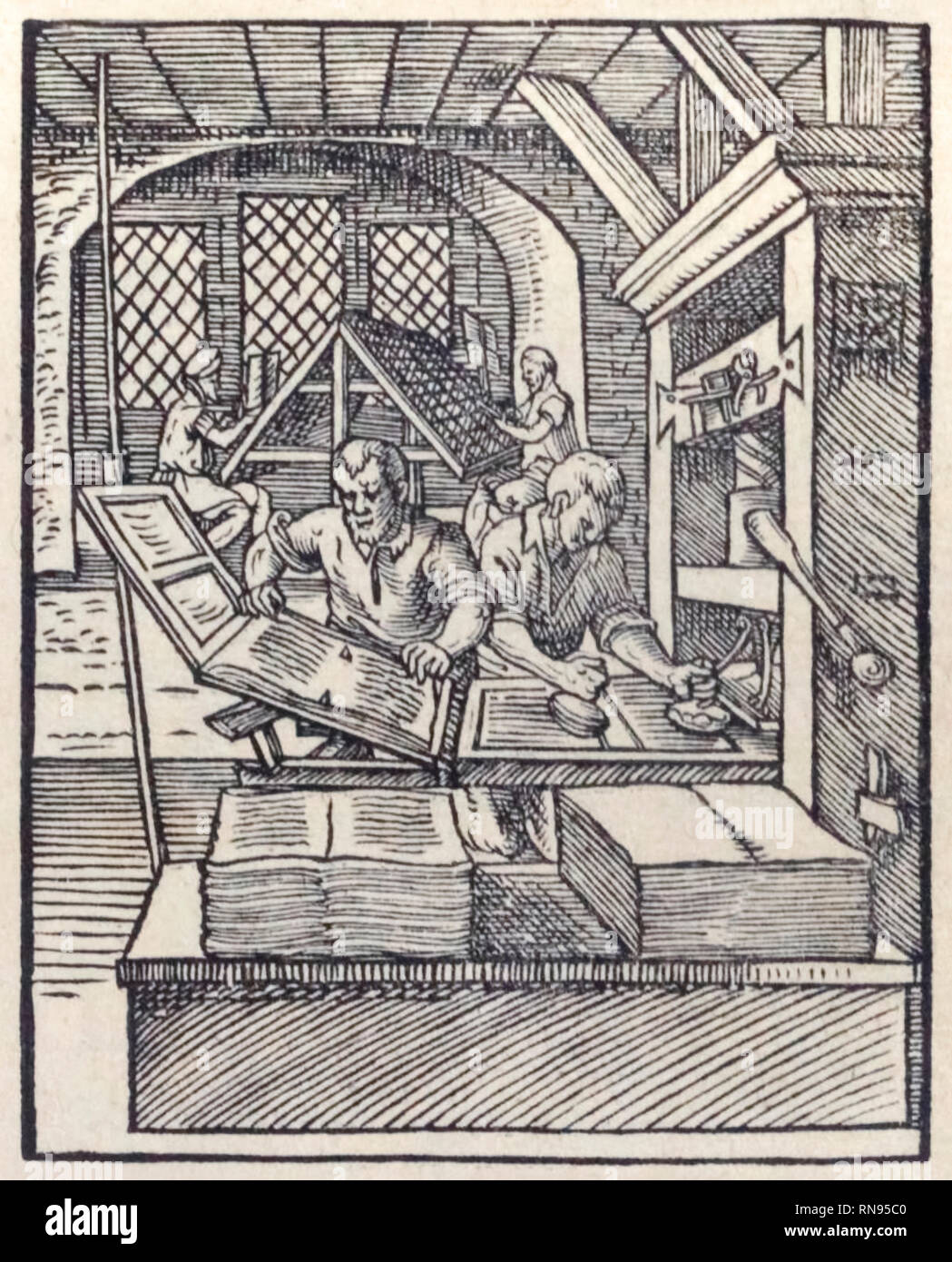 Printer’s workshop showing setting of type in background and puller and hand printing with finished pages ready for binding. From ‘[Panoplia] omnium illiberalium mechanicarum’ by Hartmann Schopper (1542-1595) printed in Frankfurt, Germany in 1568. Stock Photo