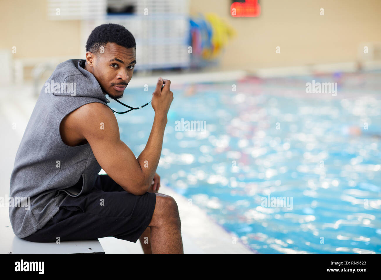 Handsome Fitness Instructor in Swimming Pool Stock Photo