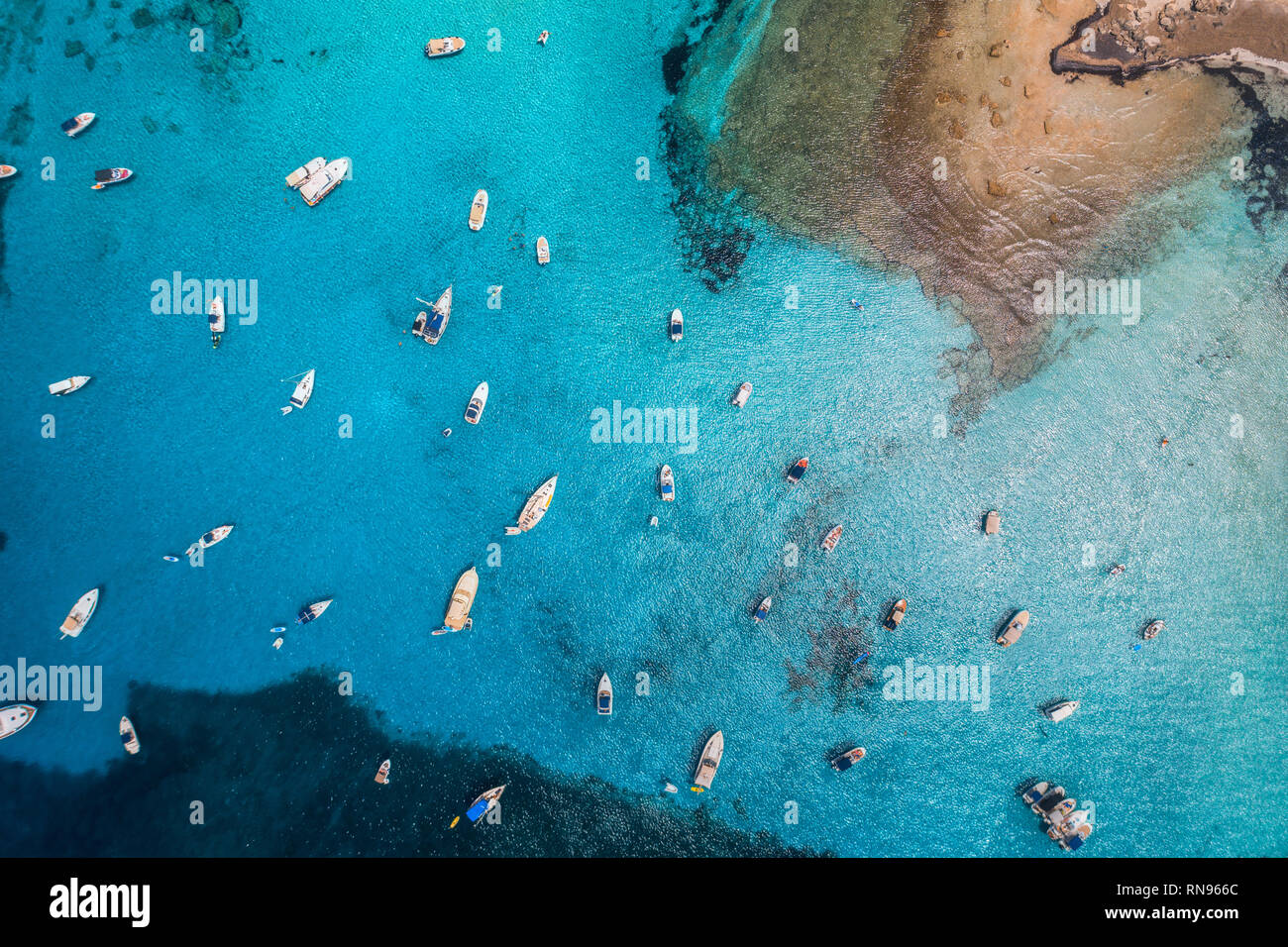 Aerial view of boats and luxury yachts in transparent blue sea at sunny ...