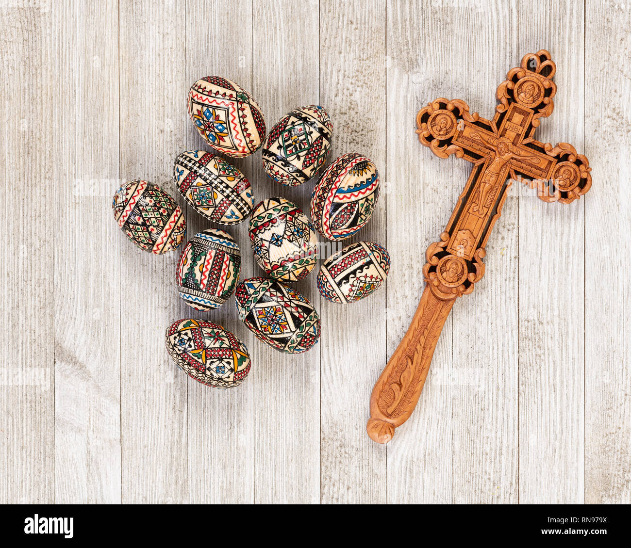 Painted wooden eggs traditional of Eastern Europe with delicately sculpted wooden cross. Stock Photo