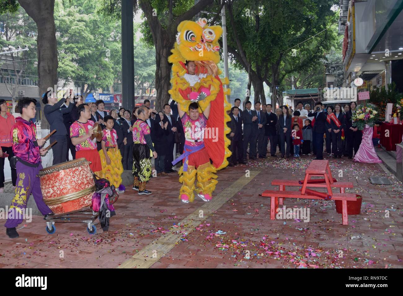 CANTON, CHINA – CIRCA FEBRUARY 2019: Group of  martial art artists give a performance of Lion Dance to bring good luck and fortune to the new bank. Stock Photo