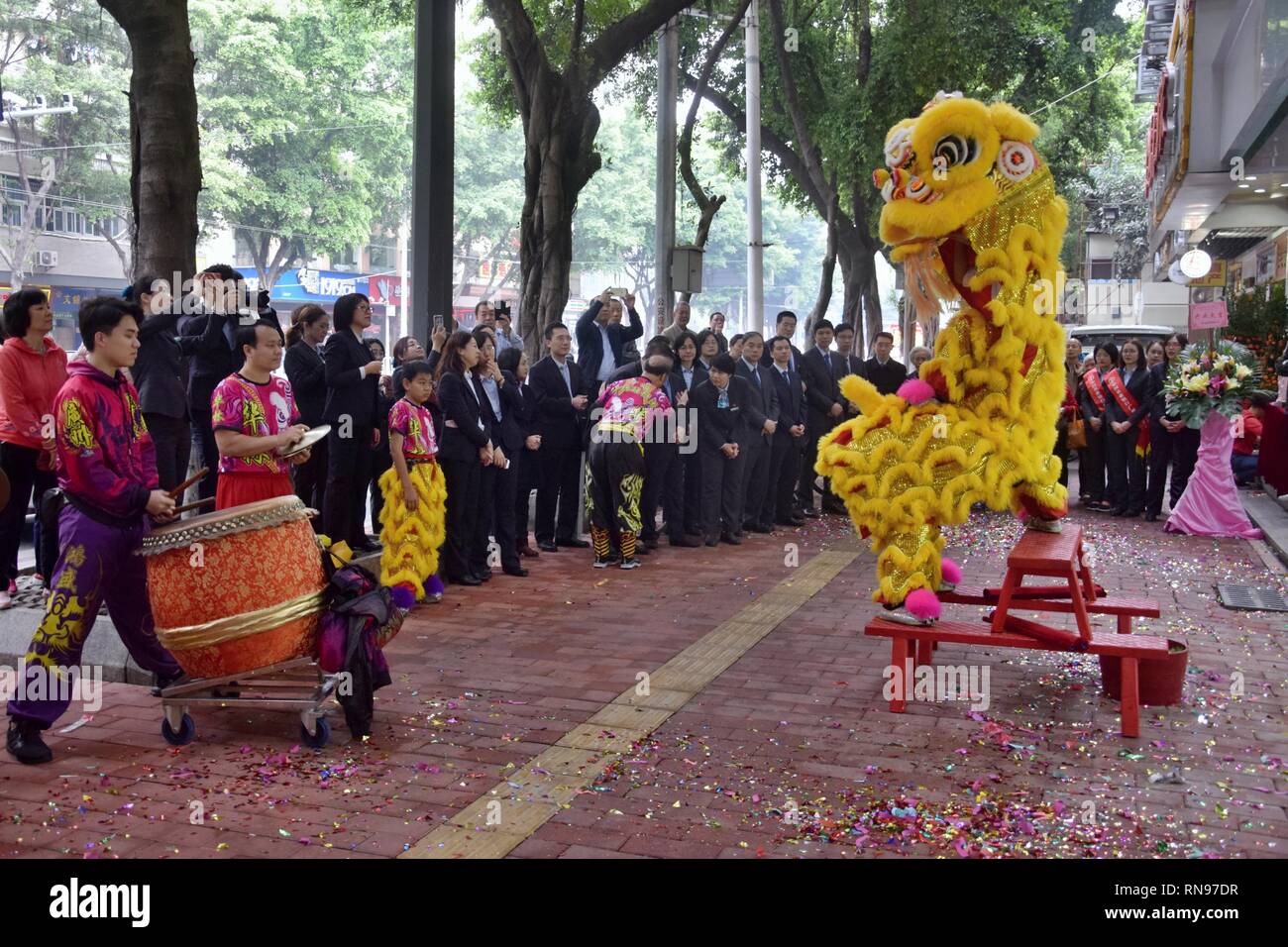 CANTON, CHINA – CIRCA FEBRUARY 2019: Group of  martial art artists give a performance of Lion Dance to bring good luck and fortune to the new bank. Stock Photo