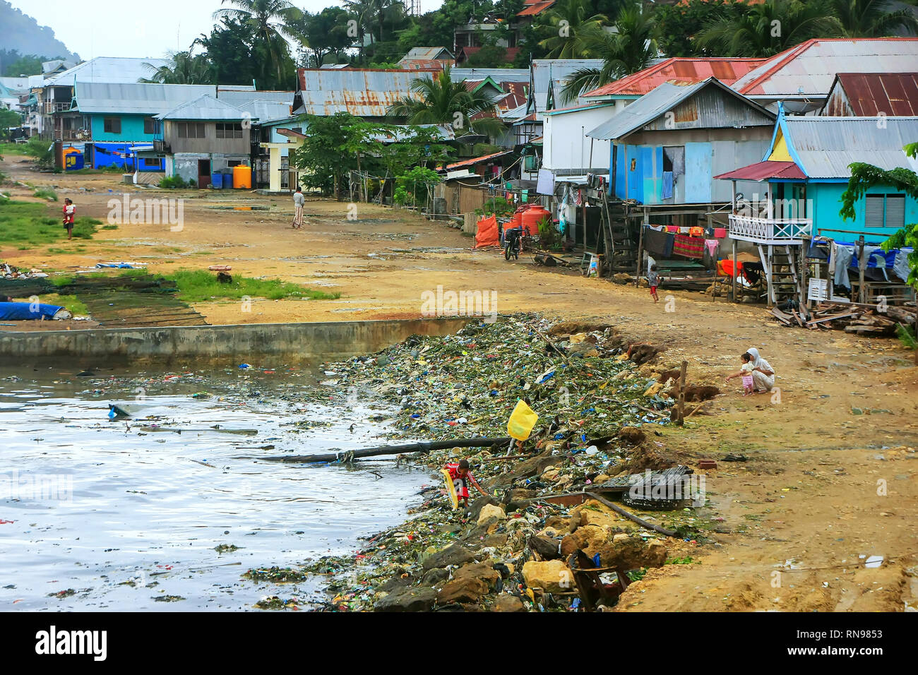 Pile of garbage in the sea at Labuan Bajo town, Flores Island, Nusa Tenggara, Indonesia. The local economy in the town is centered around the ferry po Stock Photo