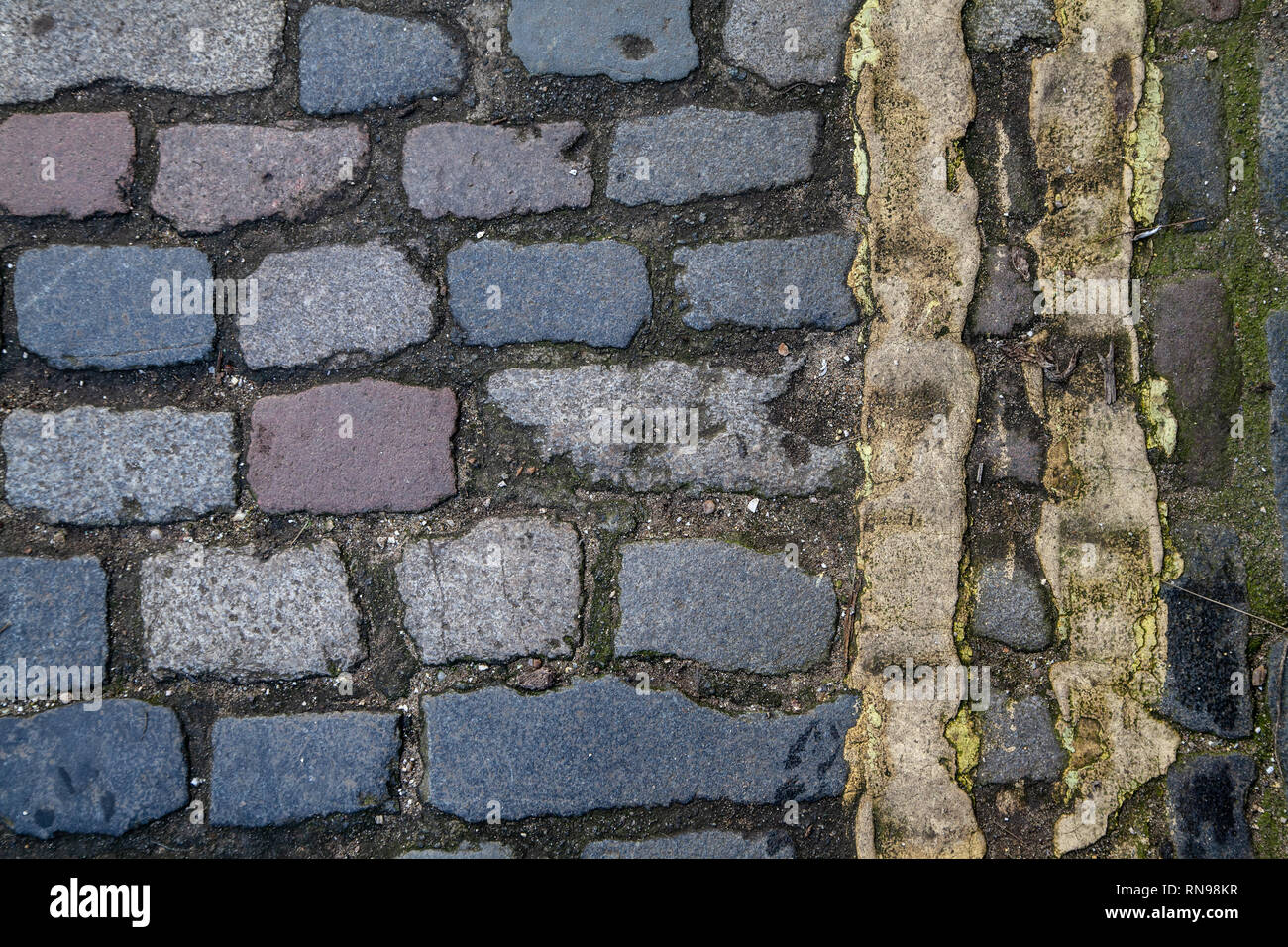 Double Yellow Lines Painted on Cobble Road Stock Photo
