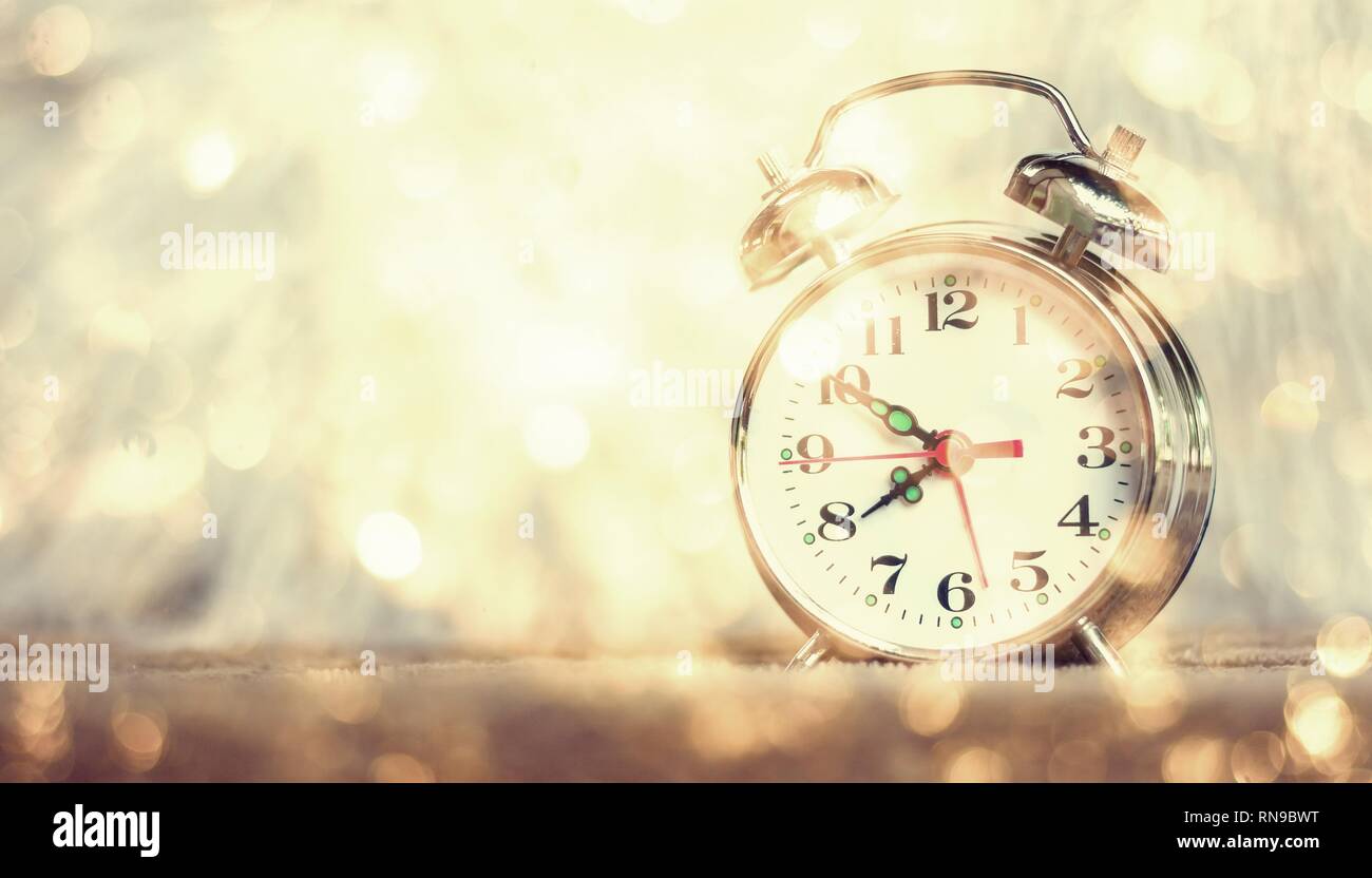 Vintage background with retro alarm clock on table Stock Photo - Alamy