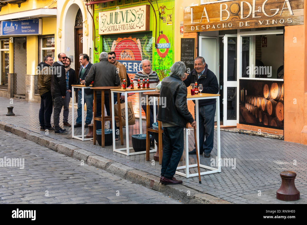 Men having a talk and a few beers at an alfresco bar in Seville, Spain Stock Photo Alamy