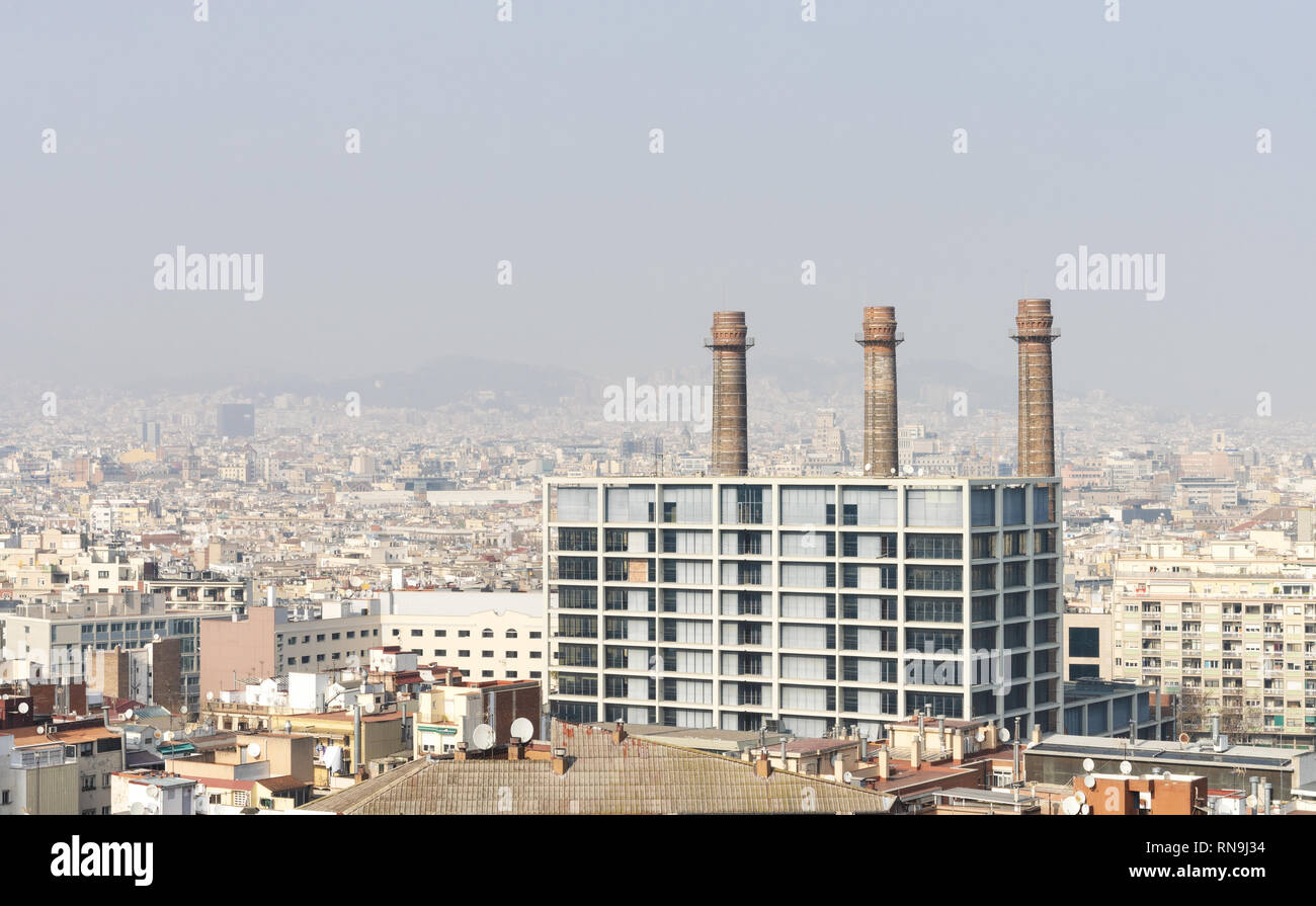 7 February 2019 - Barcelona, Spain. Picture of air polluted Barcelona city view. Industrial building with chimneys in the foreground. Stock Photo