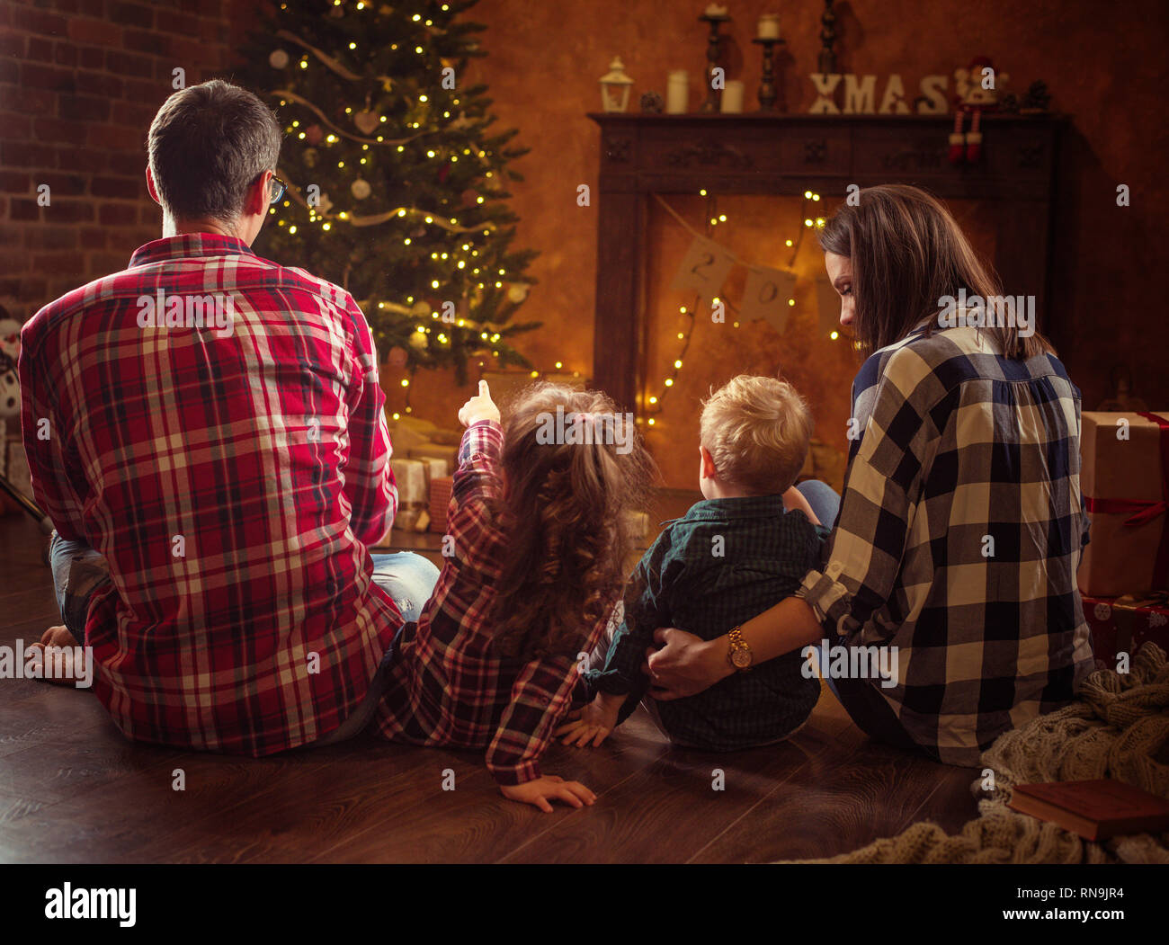 Portrait of a cheerful family realxing in a winter, calm evening Stock Photo