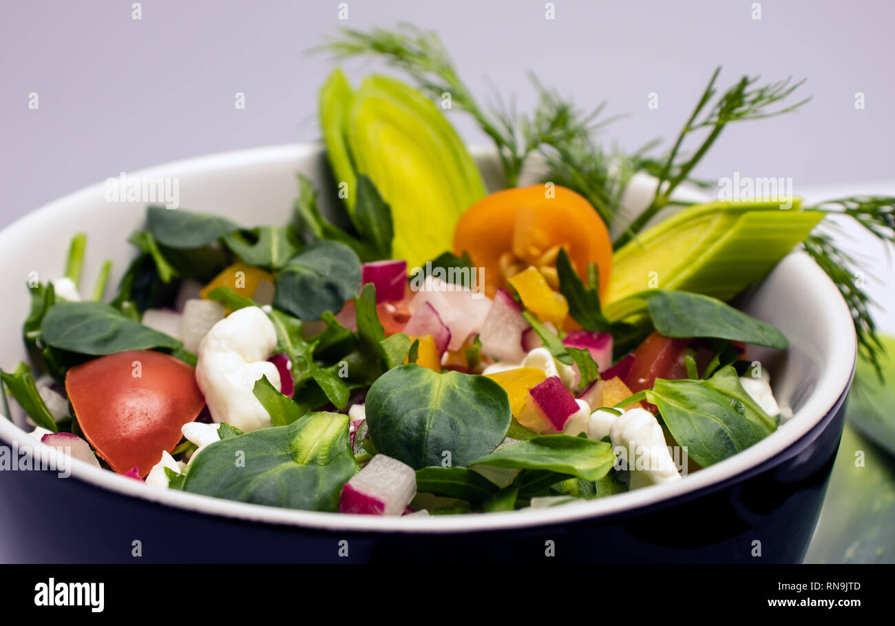 Salad of fresh vegetables with grain cottage cheese with leek and dill
