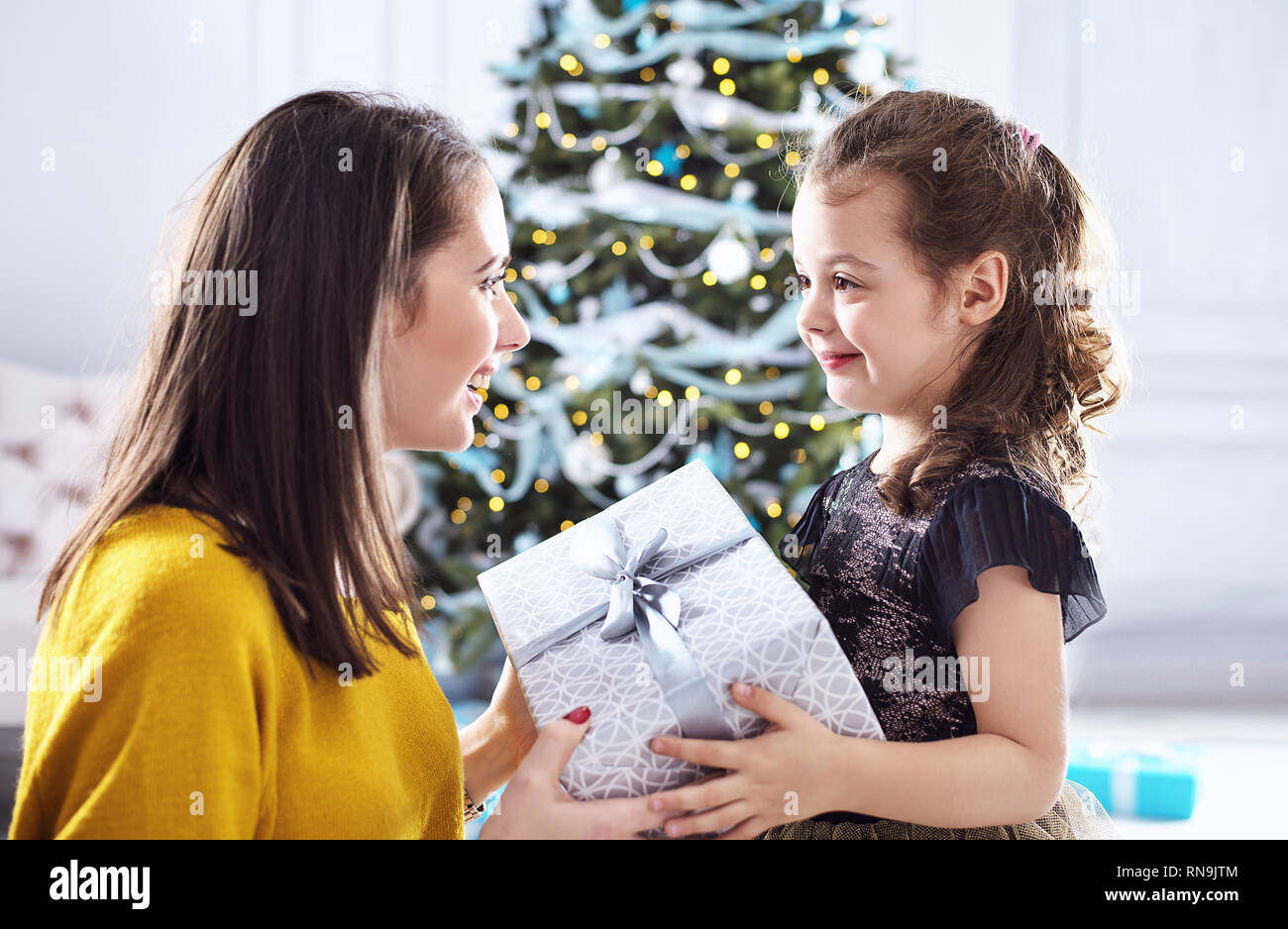 Mother giving a present to her beloved daughter Stock Photo