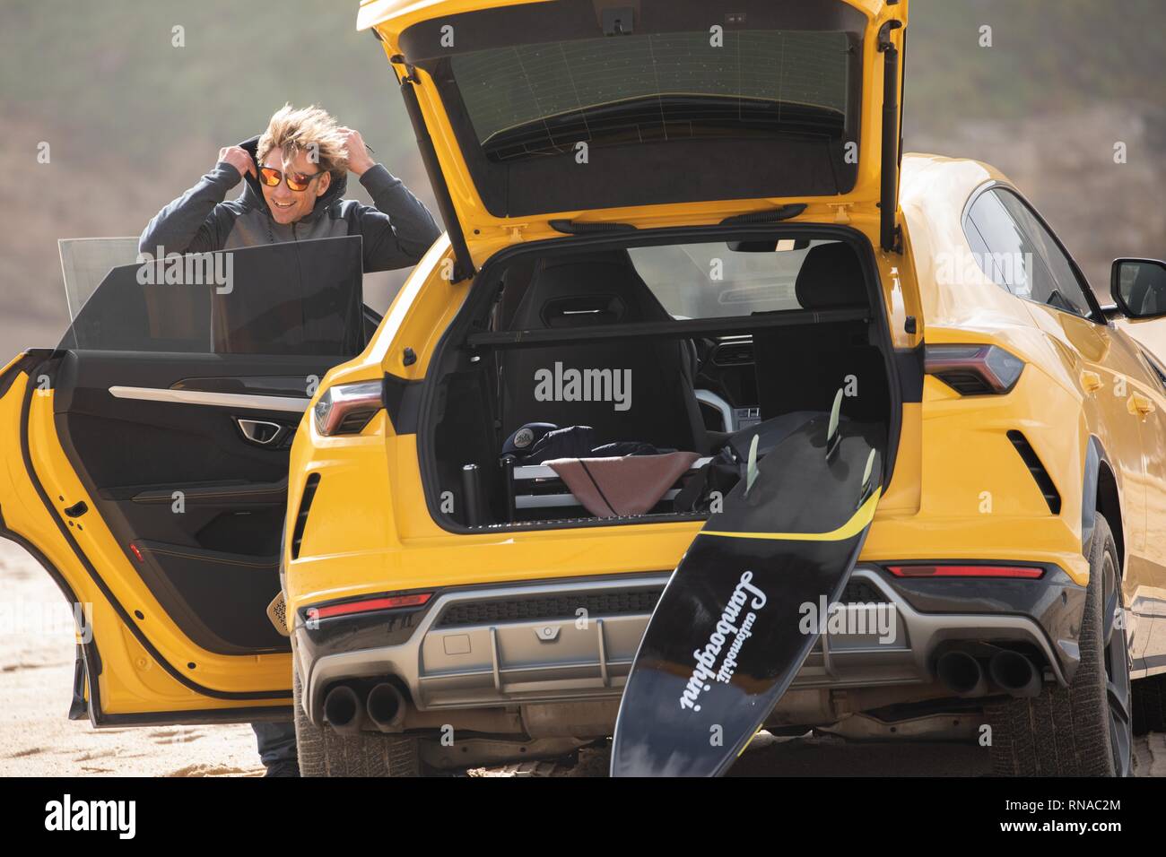 Nazare, Portugal. 18th Feb, 2019. Big wave surfer Alessandro Marciano (accent over 'o') decided to show off his brand new Lamborghini Urus 4x4 on Praia do Norte beach, on the Atlantic coast of Portugal. Alessandro, an Italian surfer spends much of his time in Nazare where the world's biggest waves are to be found. Unfortunately, Bad boy Alessandro appears to have upset the local Police and almost lost his luxury 4x4 to the incoming tide when he managed to get stuck in the soft sand. Credit: Gareth LLewelyn/Alamy Live News Stock Photo