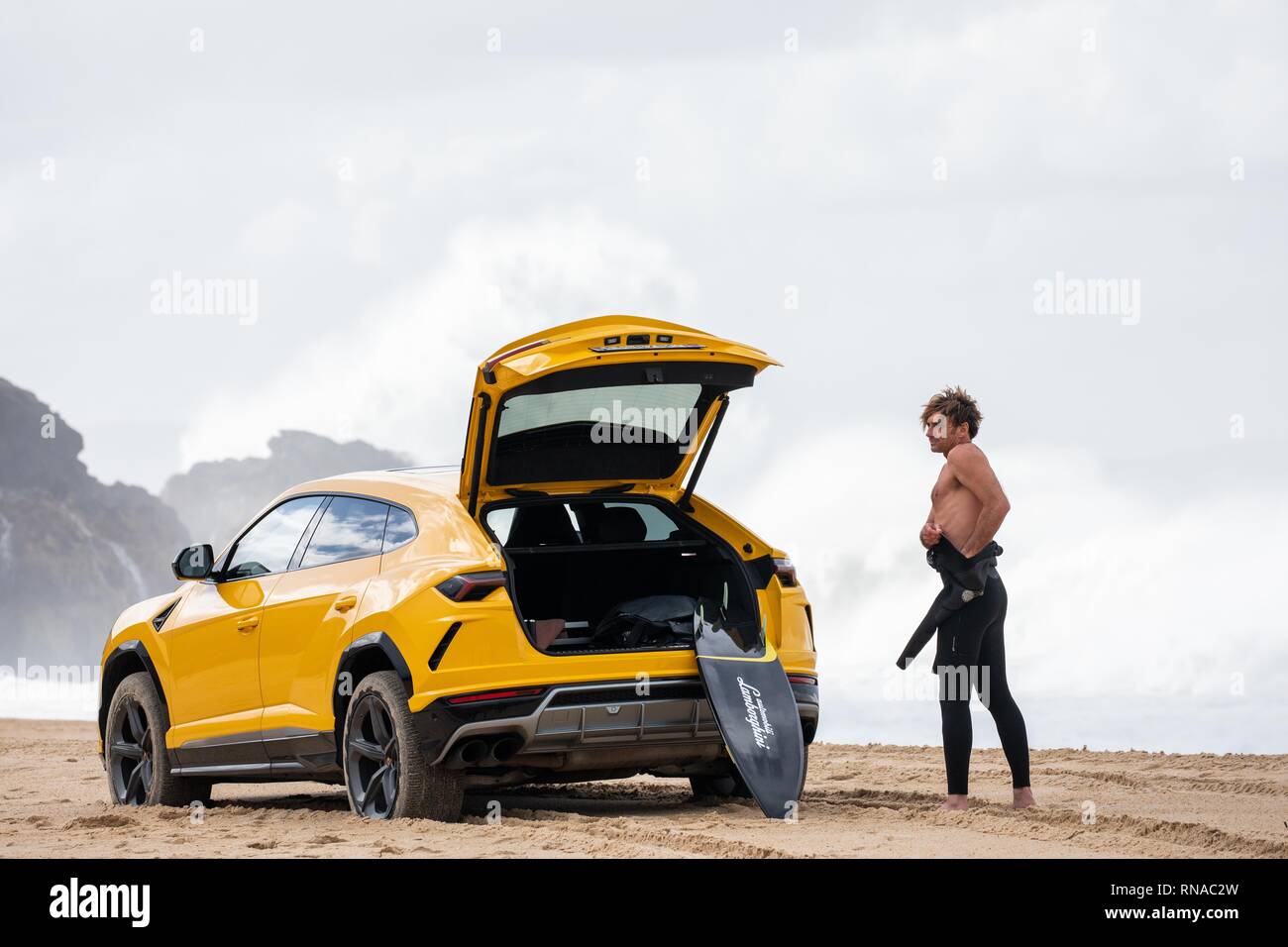 Nazare, Portugal. 18th Feb, 2019. Big wave surfer Alessandro Marciano (accent over 'o') decided to show off his brand new Lamborghini Urus 4x4 on Praia do Norte beach, on the Atlantic coast of Portugal. Alessandro, an Italian surfer spends much of his time in Nazare where the world's biggest waves are to be found. Unfortunately, Bad boy Alessandro appears to have upset the local Police and almost lost his luxury 4x4 to the incoming tide when he managed to get stuck in the soft sand. Credit: Gareth LLewelyn/Alamy Live News Stock Photo