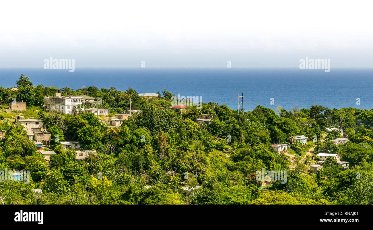 Aerial landscape and ocean view on homes/houses in the coastal mountains of a Caribbean island. Saint Ann/ St Ann Jamaica. Stock Photo