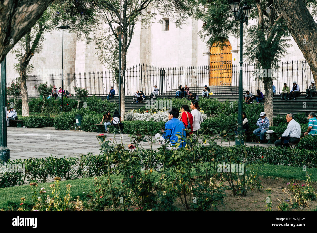 Locals sitting, relaxing and walking in a park in Arequipa, Peru. Stock Photo