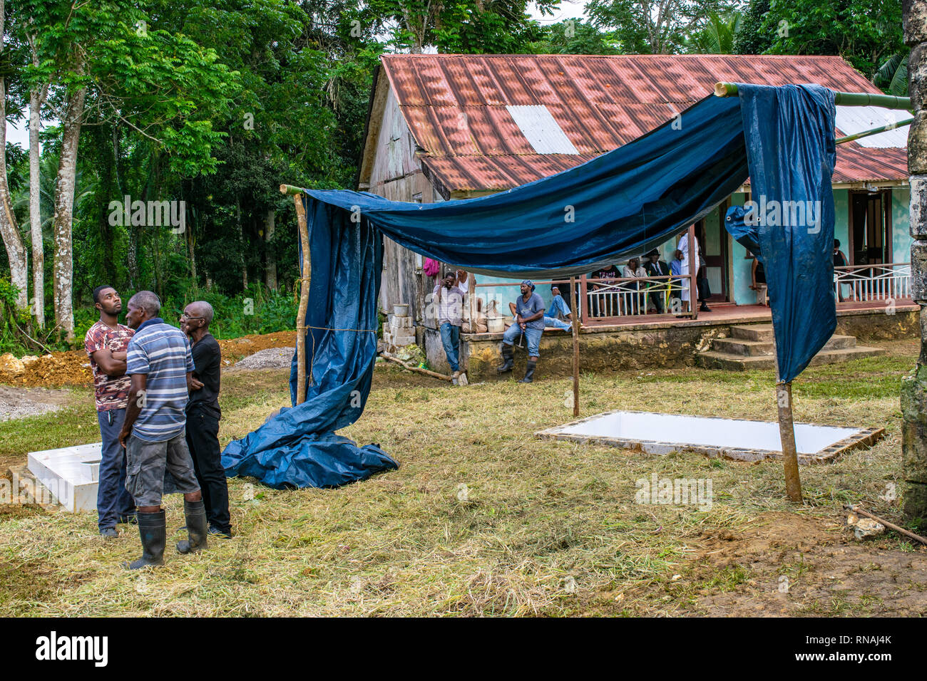 Saint Mary, Jamaica - January 07 2017: Scene at a cemetery as mourners gather for burial service of a deceased member of their community. Stock Photo