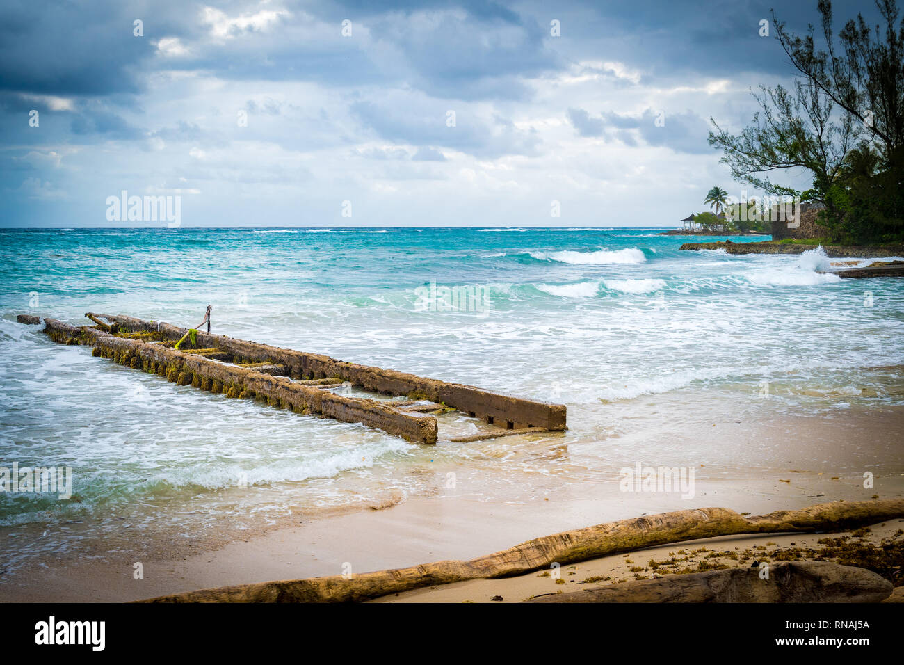 Cloudy/stormy day at the beach in Jamaica in the hurricane season. Cloudy skies, heavy wind gusts, high tides. Stock Photo