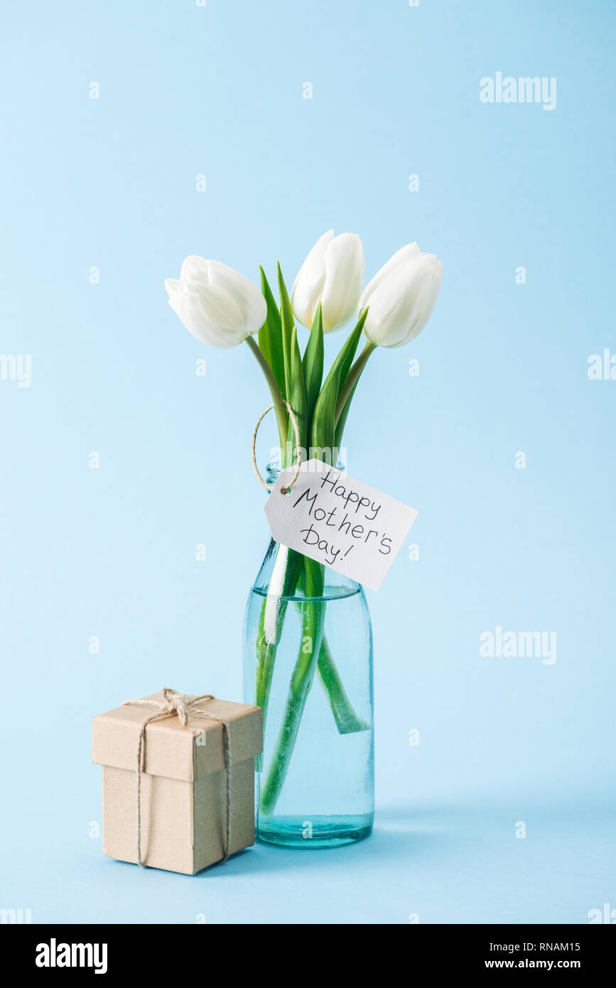 gift box and bouquet of white tulips with happy mothers day greeting ...