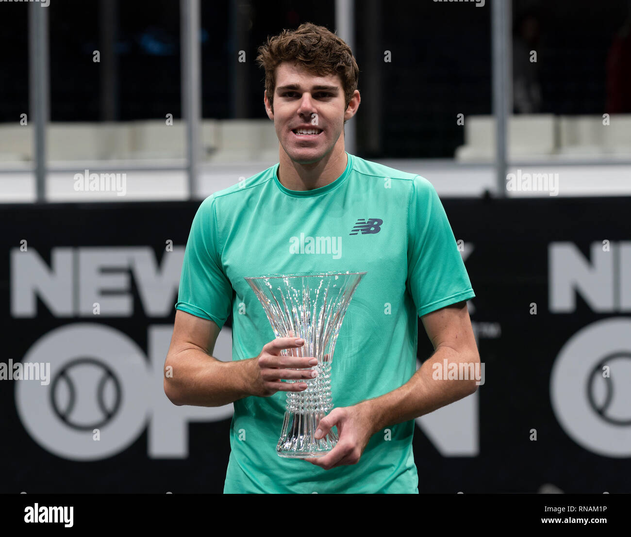 heampstead-united-states-17th-feb-2019-reilly-opelka-of-usa-holds-winner-trophy-after-defeating-brayden-schnur-of-canada-at-final-of-new-york-open-atp-250-tournament-at-nassau-coliseum-credit-lev-radinpacific-pressalamy-live-news-RNAM1P.jpg