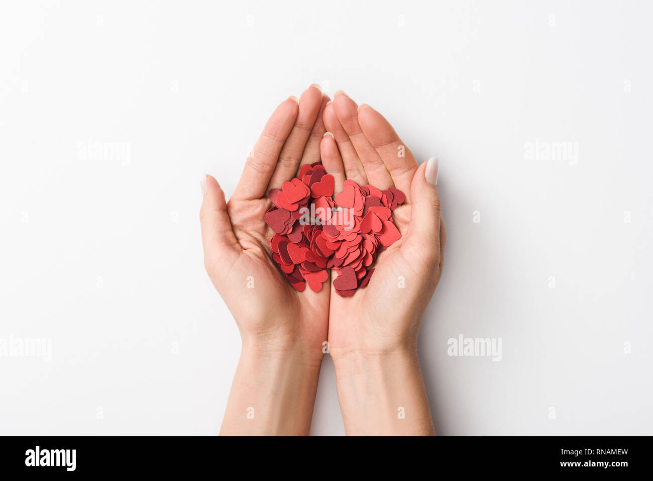 Cropped view of woman holding paper hearts on white background Stock Photo