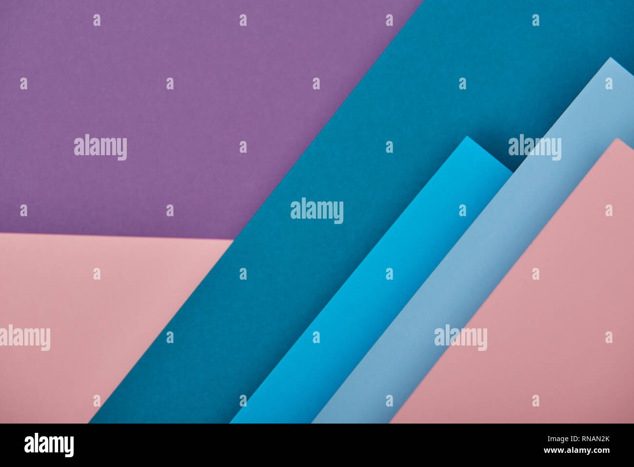 top view of blue, pink and violet paper sheets with copy space Stock Photo