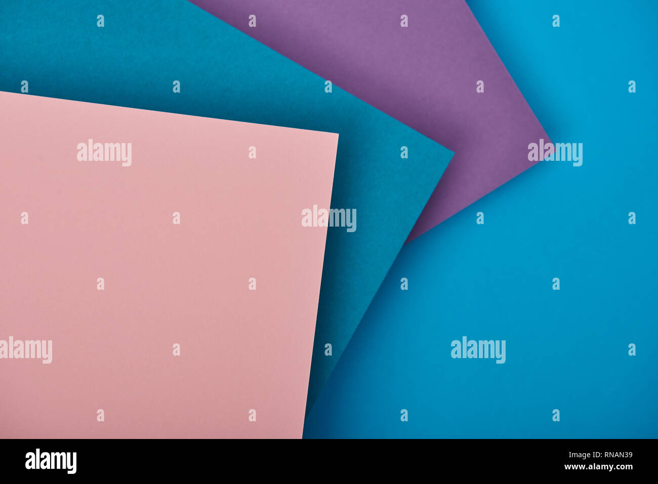 top view of blue, purple and pink paper sheets with copy space Stock Photo