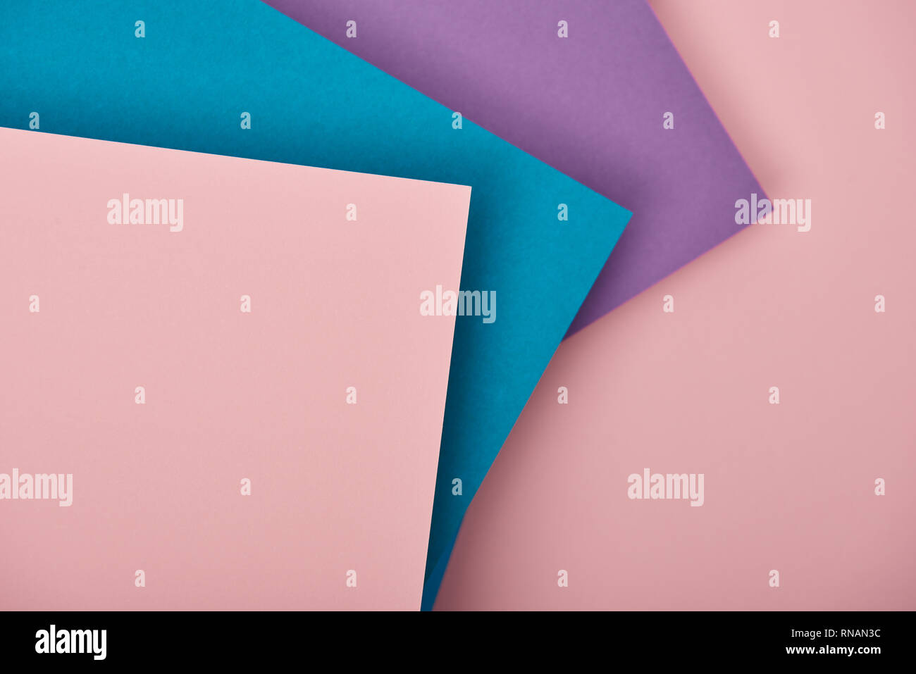 top view of violet, blue and pink paper sheets with copy space Stock Photo
