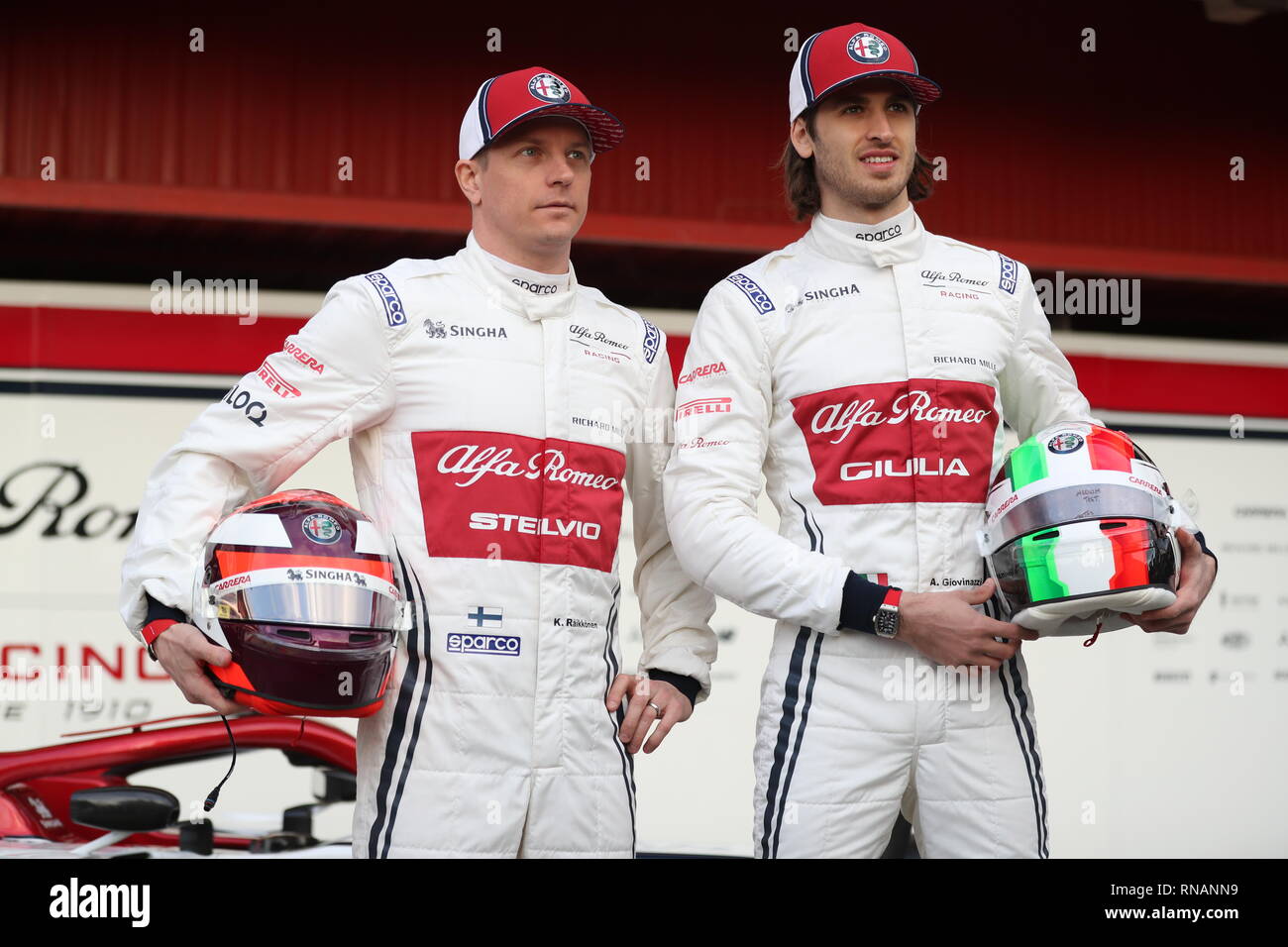 Drivers Kimi Raikkonen (left) and Antonio Giovinazzi during the new livery presentation of Alfa Romeo's F1 car at the Circuit de Barcelona-Catalunya. Stock Photo