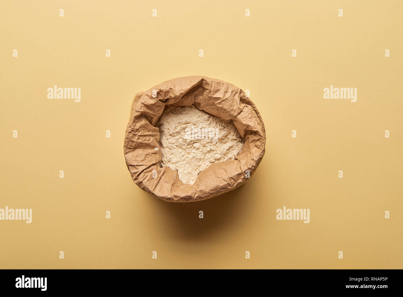Top View Of Paper Bag Full Of Flour On Yellow Background Stock Photo Alamy