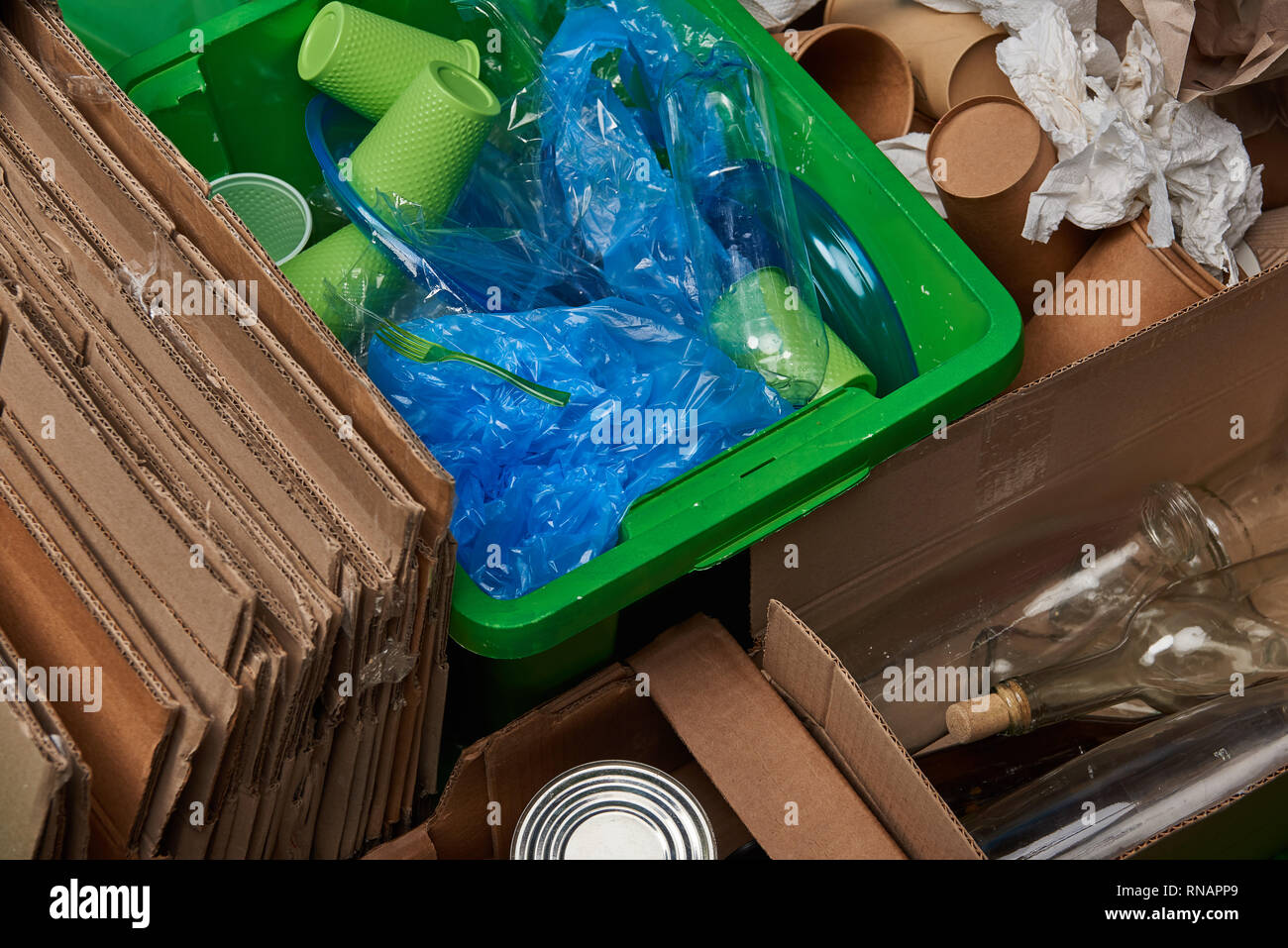 sorted trash of cardboard, glass bottles, polyethylene, plastic and paper cups Stock Photo