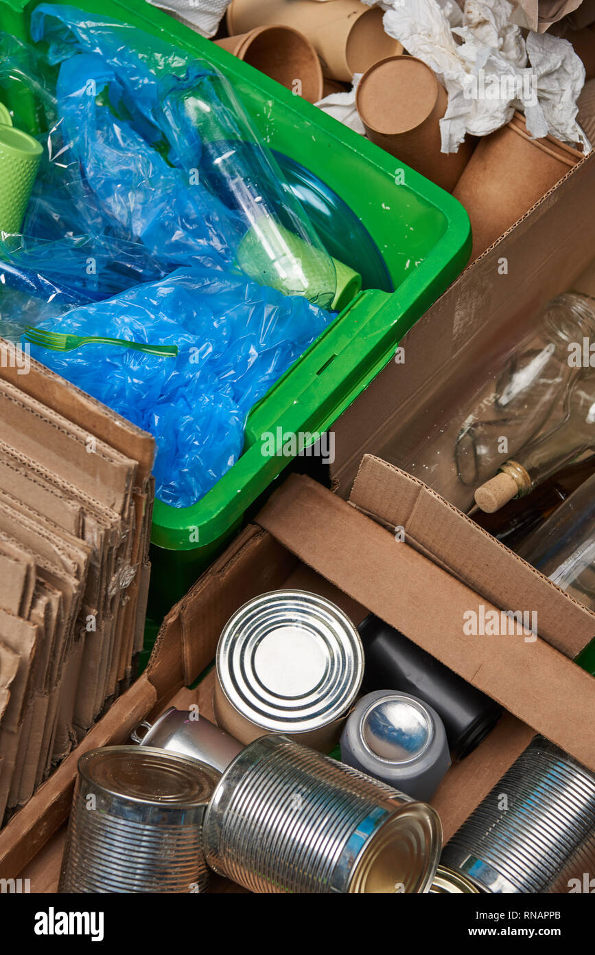 sorted trash of cardboard, glass and plastic bottles, polyethylene, cups, iron cans Stock Photo
