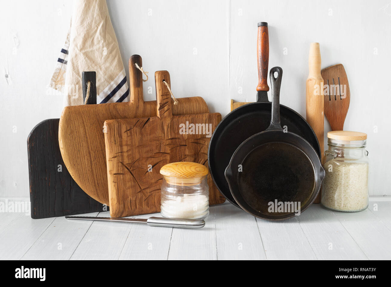 Rustic still life. Set of wooden kitchen utensils on white wooden kitchen table Stock Photo